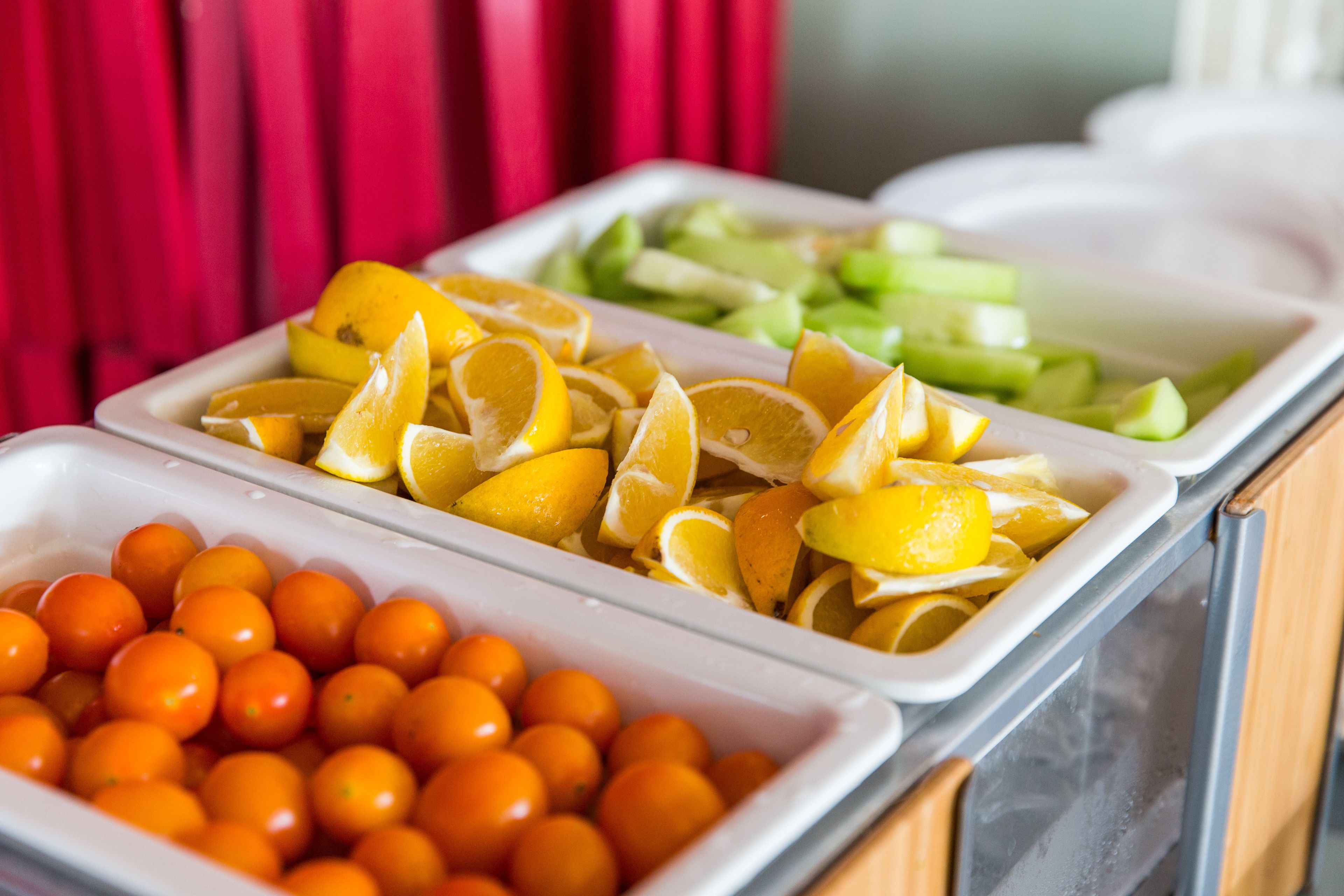 A buffet with various fruits and vegetables.