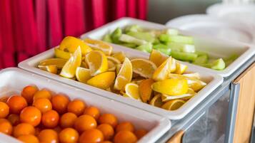 A buffet with various fruits and vegetables.