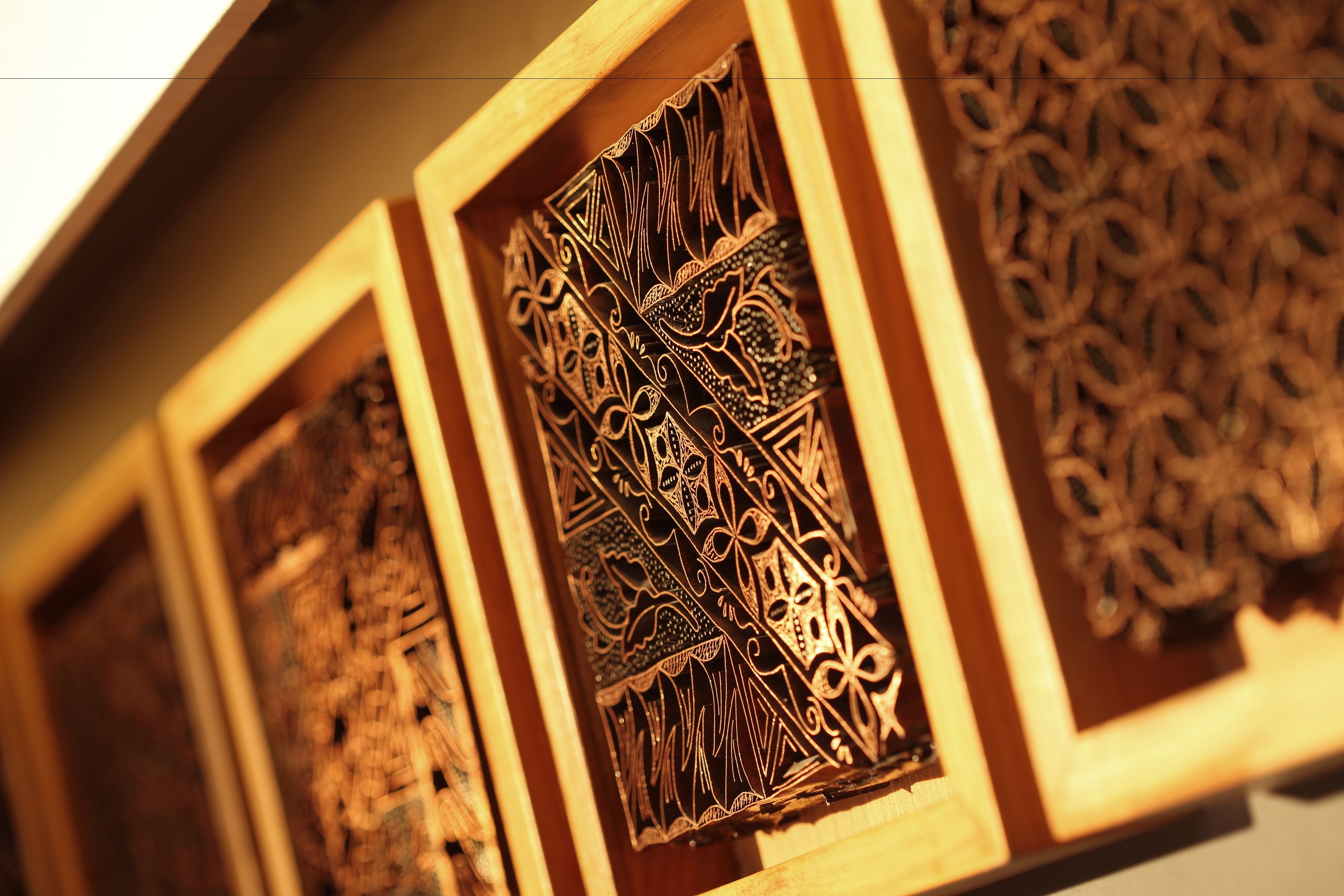 A series of intricately carved wooden panels, likely part of a decorative architectural feature.