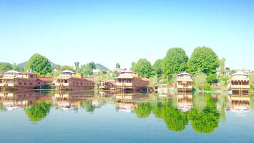 A row of traditional buildings with reflective water in the foreground.