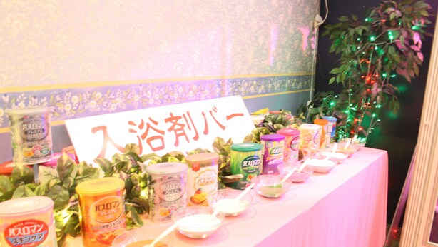 A table with various food items and a sign in Japanese. - Hotel TROPICAL OSAKA - Adults Only (Osaka)