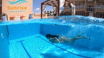 Outdoor pool, pool umbrellas, pool loungers