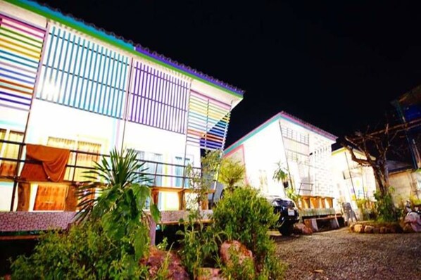A multi-story building with a series of balconies and a covered outdoor area.