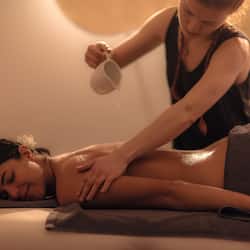 Experience a rejuvenating massage on a comfortable massage table, complete with a soothing ambiance.