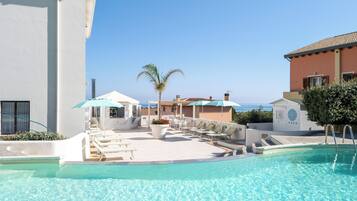 Seasonal outdoor pool, open 9:00 AM to 6:00 PM, pool umbrellas