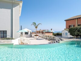 Seasonal outdoor pool, open 9:00 AM to 6:00 PM, pool umbrellas