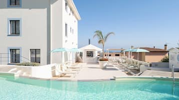 Seasonal outdoor pool, open 9:00 AM to 6:00 PM, pool umbrellas