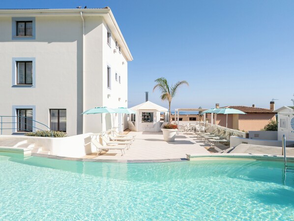 Seasonal outdoor pool, open 9:00 AM to 6:00 PM, pool umbrellas