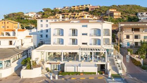 A hotel with multiple floors, balconies, and a terrace area. - Hotel Blumarea, BW Signature Collection (Castelsardo)