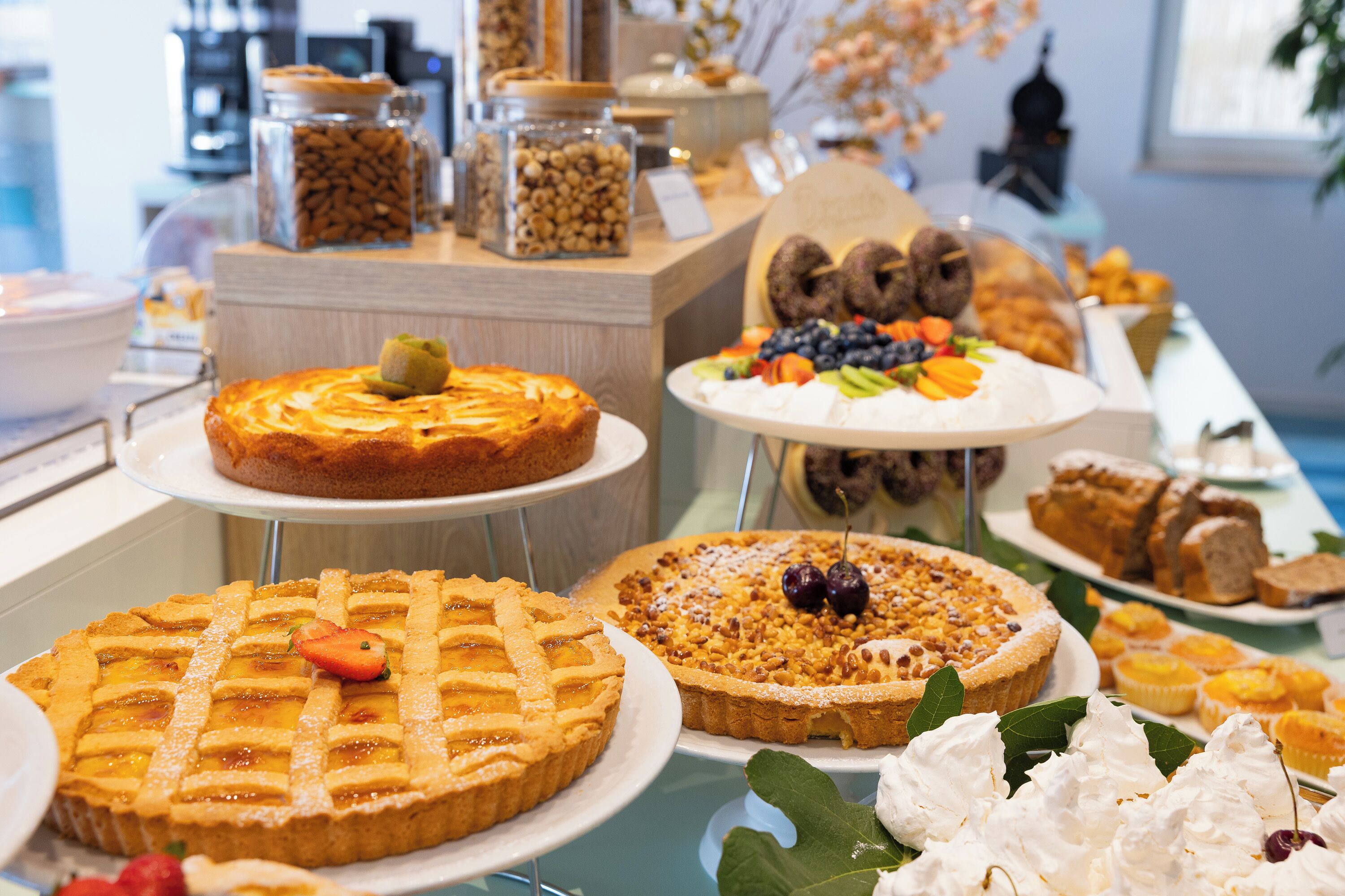 A buffet with various desserts including pies, cakes, and pastries.