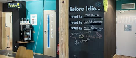 A kitchen area with a chalkboard wall listing personal goals.
