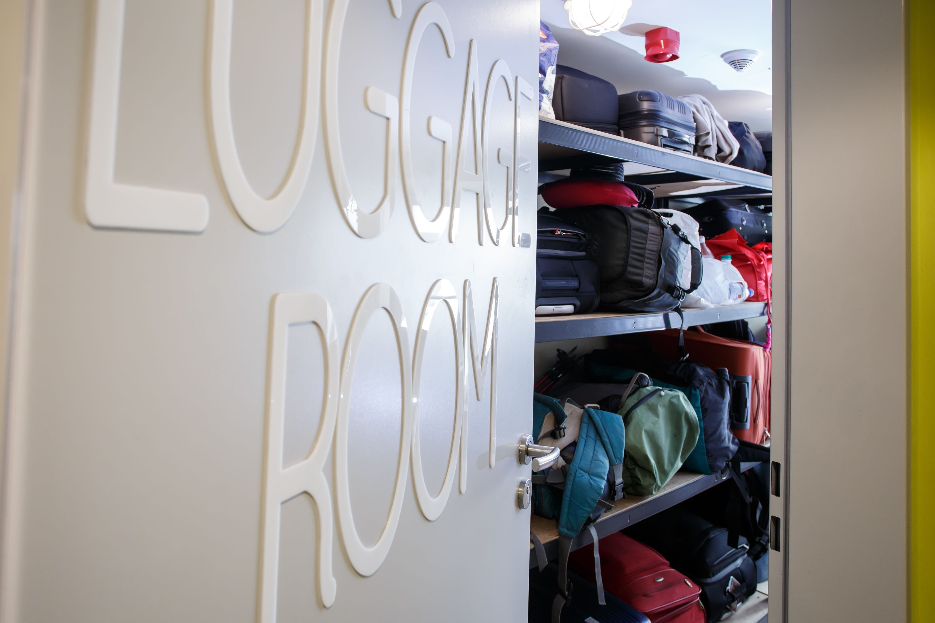 A luggage room with shelves filled with suitcases and bags.