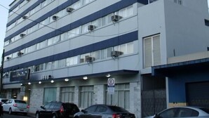 A multi-story hotel with a prominent 'HOTEL' sign on the facade. - Hotel Itajaí Tur (Itajai)