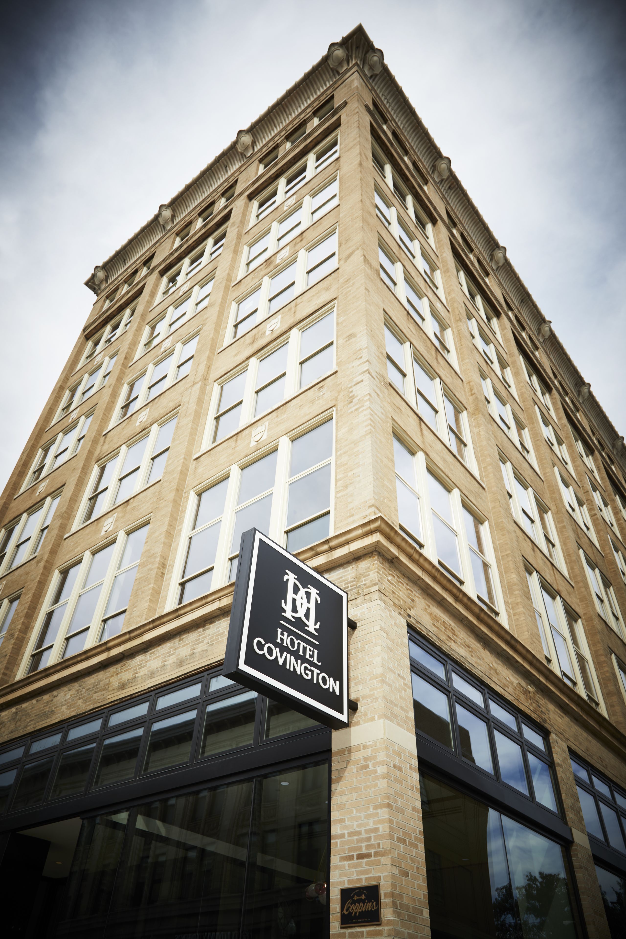 A tall, multi-story building with a sign indicating it is the Hotel Covington.