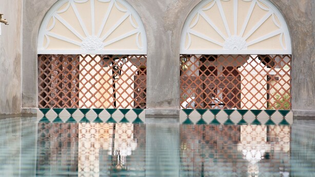 A pool with arched openings and a tiled floor. - Jawi Peranakan Mansion (George Town)