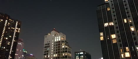 A nighttime cityscape with high-rise buildings.