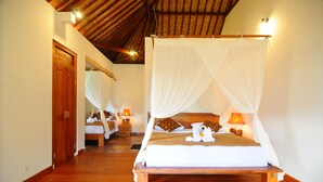 A bedroom with a wooden bed, white canopy, and bedside lamps. - Villa Lihat Sawah (Sidemen)