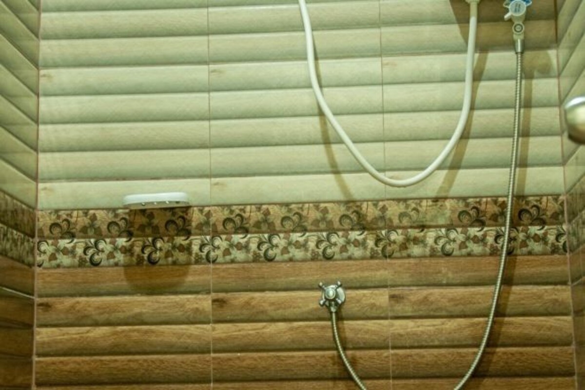 Une salle de bain avec des lambris en bois et un espace douche.