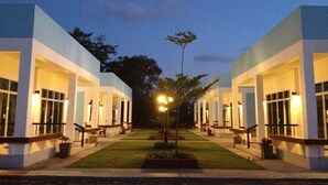 A modern hotel with a symmetrical facade, large windows, and a well-maintained lawn. - The Cube Resort (Chanthaburi)