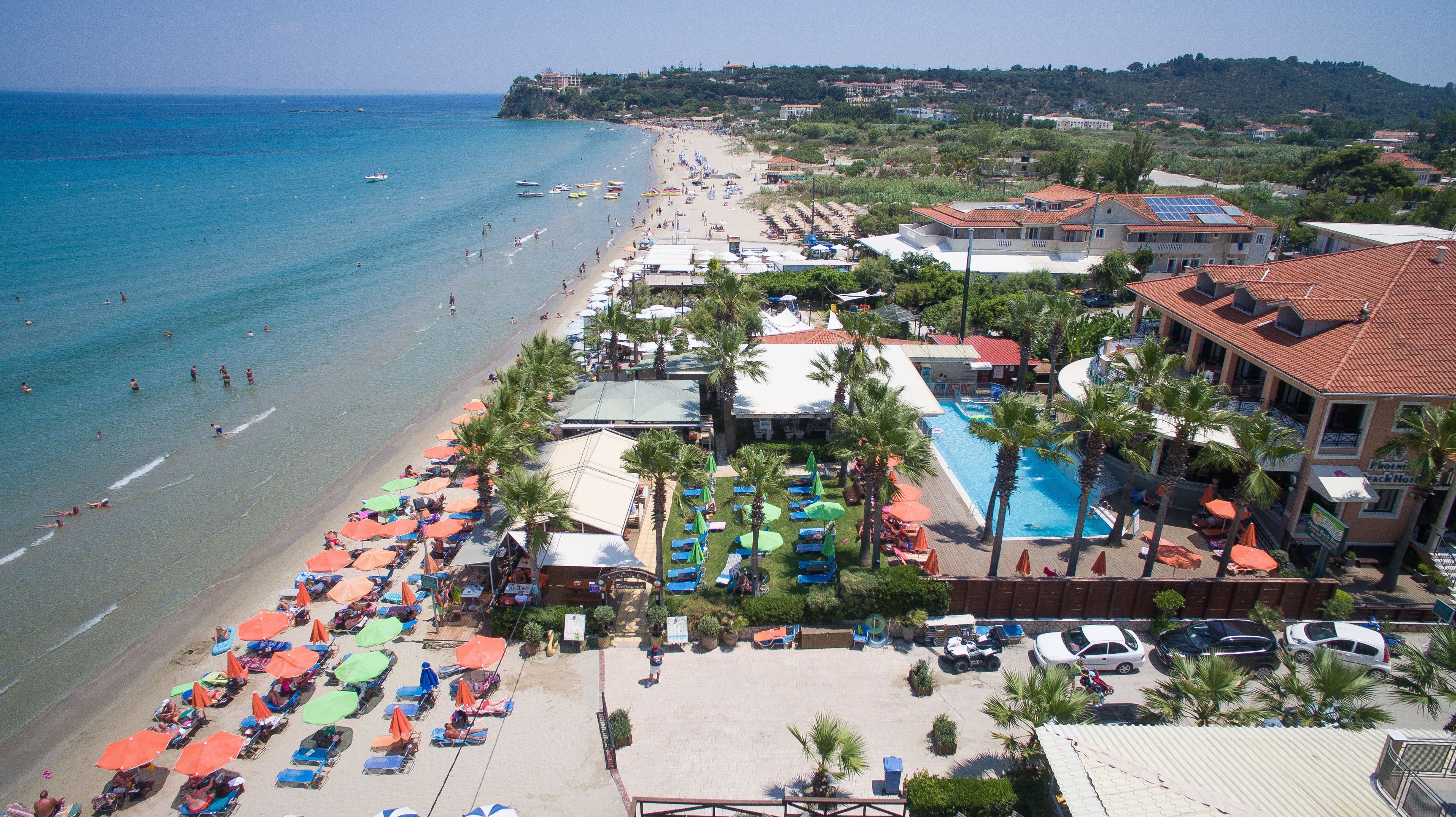 On the beach, white sand, sun-loungers, beach umbrellas