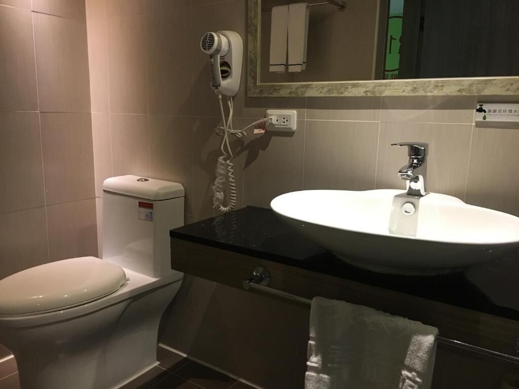 shower, hair dryer, slippers, towels