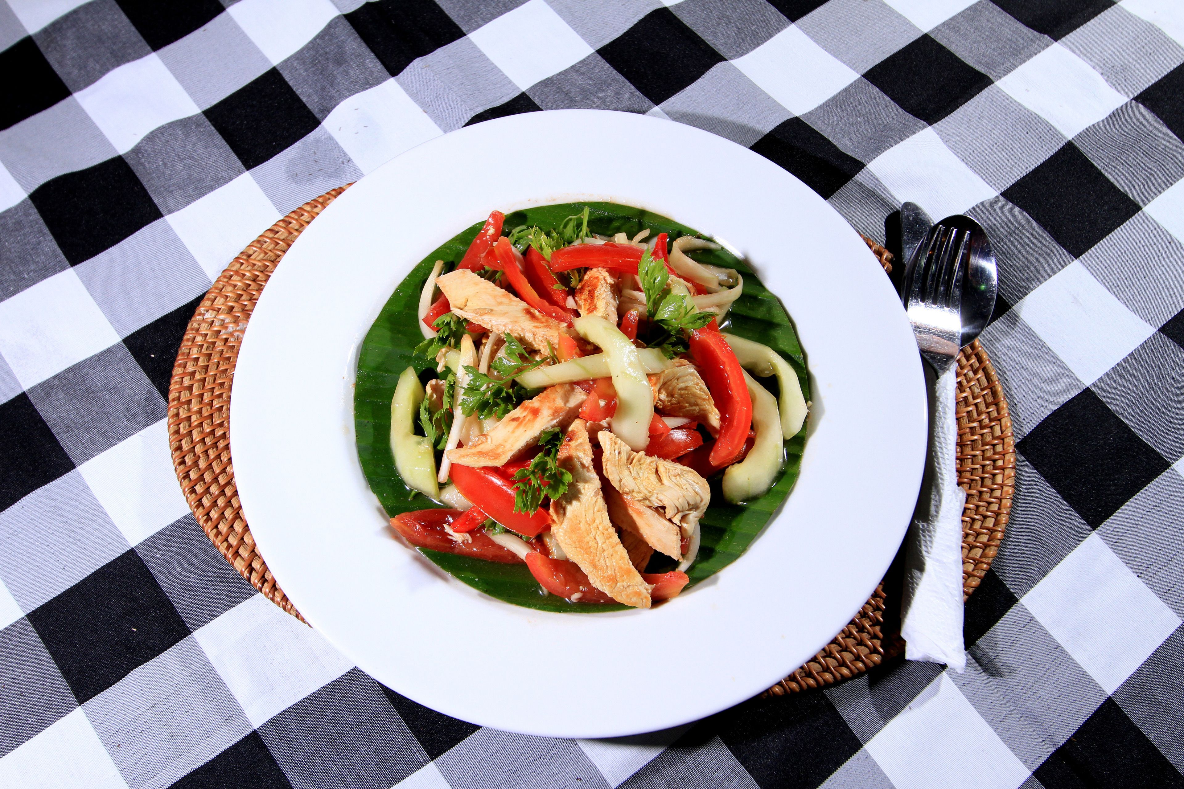 A plate of food on a checkered tablecloth.