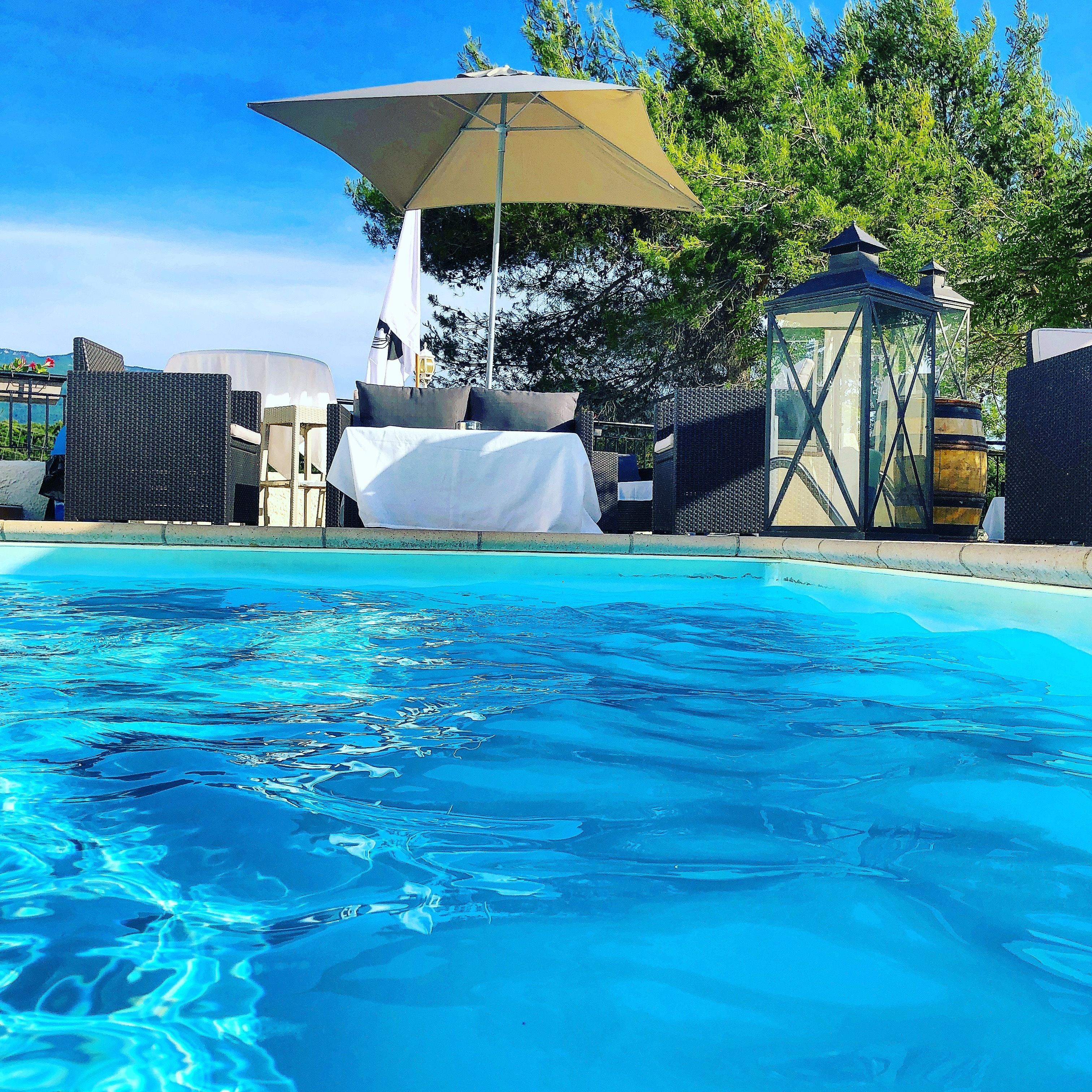 seasonal outdoor pool, open 9:00 am to 7:00 pm, pool umbrellas