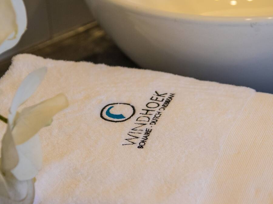 A white towel with a logo and text indicating a windhoek location.