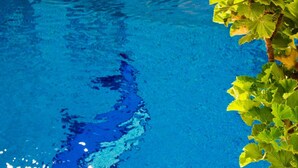 A clear blue pool with visible ripples and reflections. - Unique Leta (Santorini)