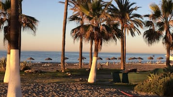On the beach, sun-loungers, beach umbrellas, beach towels