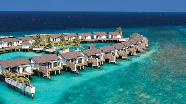 An overwater resort with multiple bungalow-style accommodations connected by walkways over clear turquoise water. - Atmosphere Kanifushi - Premium All Inclusive with Free Transfers (Kanifushi)