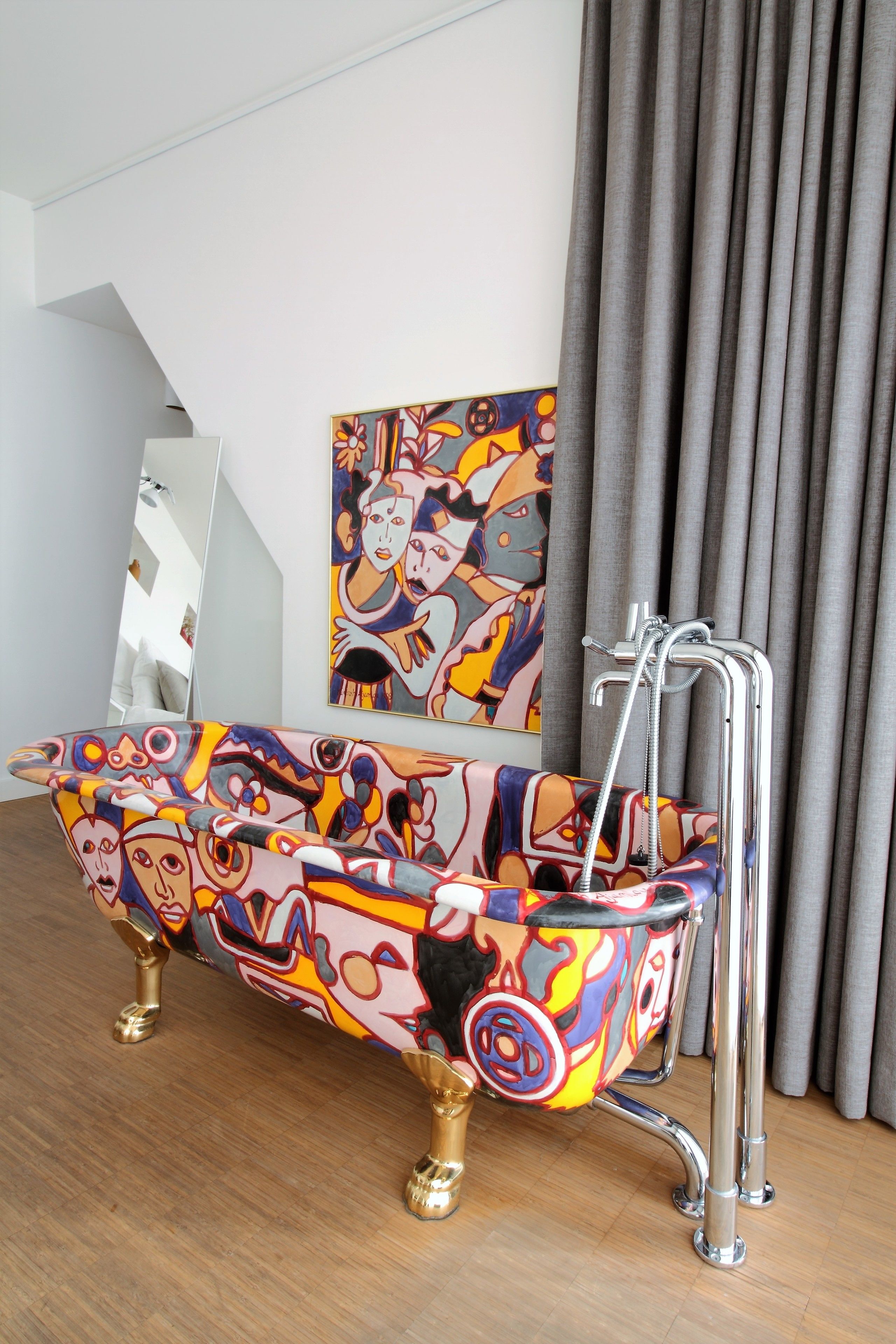 Une salle de bain avec une baignoire aux couleurs vives, une douche et un grand miroir.