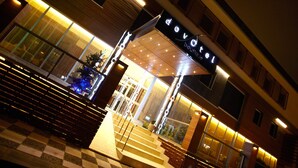 A hotel entrance with a checkered floor, a staircase, and a sign reading "Devotel Boutique Hotel". - dovsOtel (Manisa)