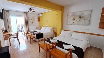 Deluxe Quadruple Room, Terrace, Sea View | Minibar, individually decorated, individually furnished, desk