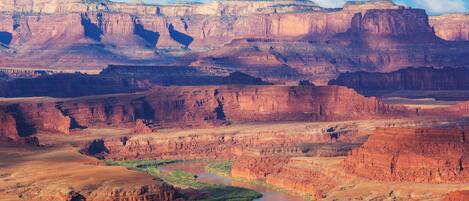 A canyon landscape with a river and cliffs.