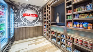 A snack and sundries section with shelves stocked with various packaged snacks and drinks.
