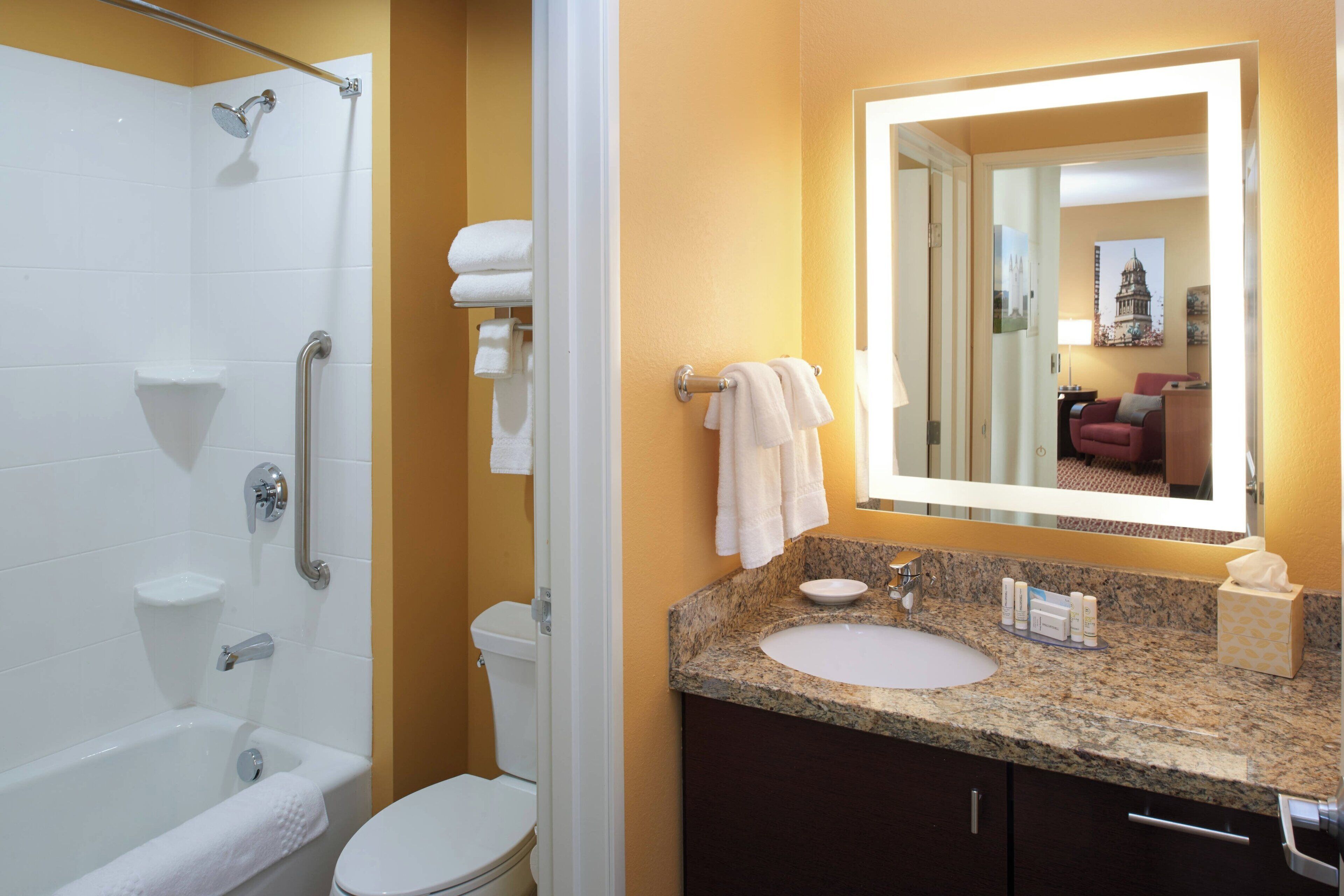 combined shower/bathtub, designer toiletries, hair dryer, towels