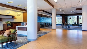 A spacious lobby with a reception desk, seating area, and large windows. - Fairfield Inn & Suites Richmond Midlothian (Richmond)