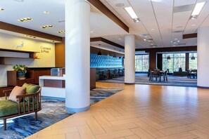 A spacious lobby with a reception desk, seating area, and large windows. - Fairfield Inn & Suites Richmond Midlothian (Richmond)