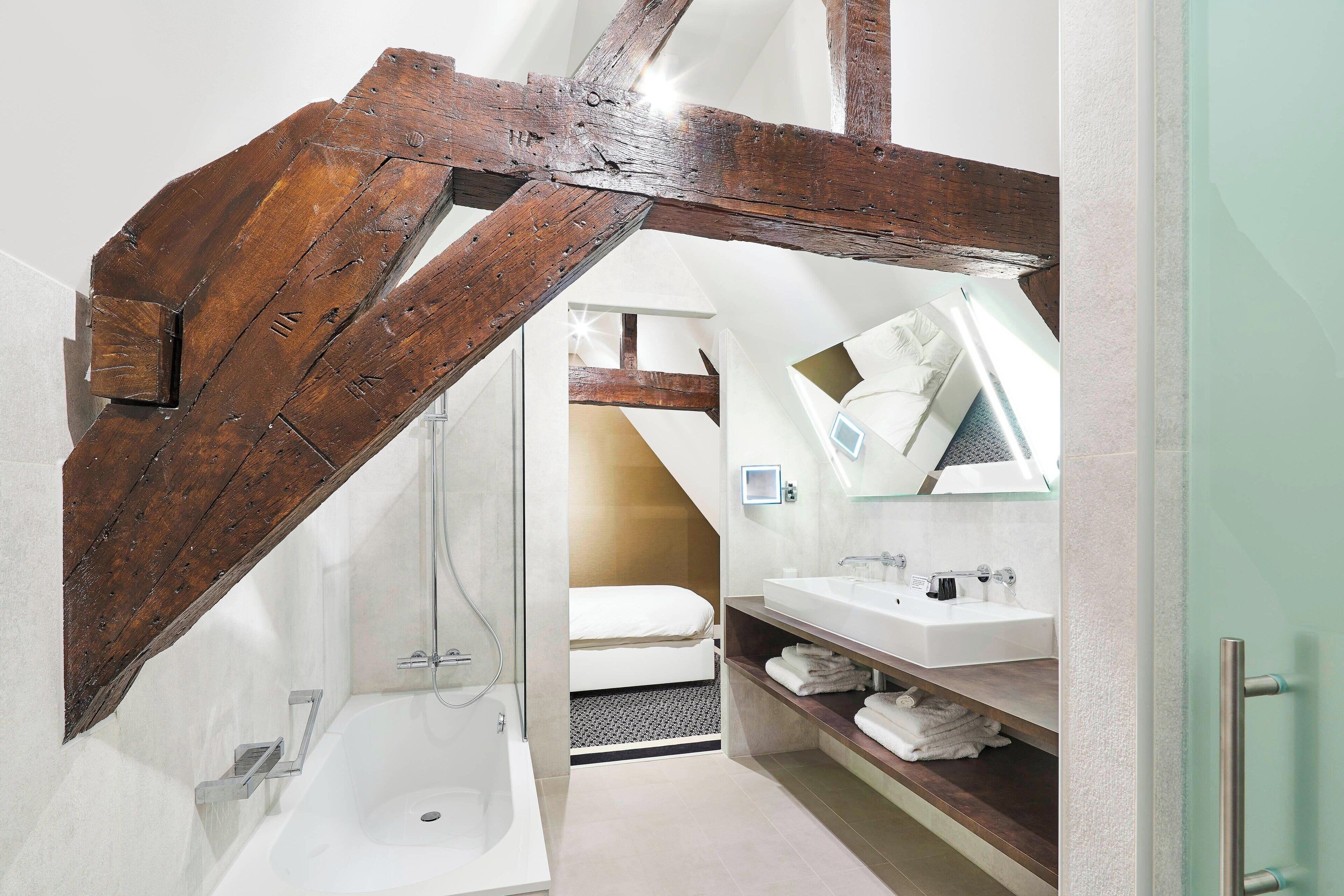 junior suite, 1 king bed, non smoking | bathroom | rainfall showerhead, designer toiletries, hair dryer, towels