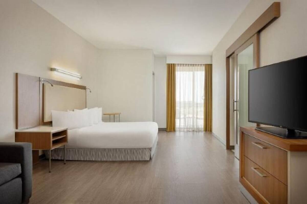 Hypo-allergenic bedding, desk, laptop workspace, blackout drapes