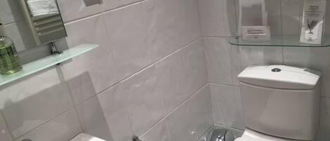 A modern bathroom with a bidet, toilet, and sink.