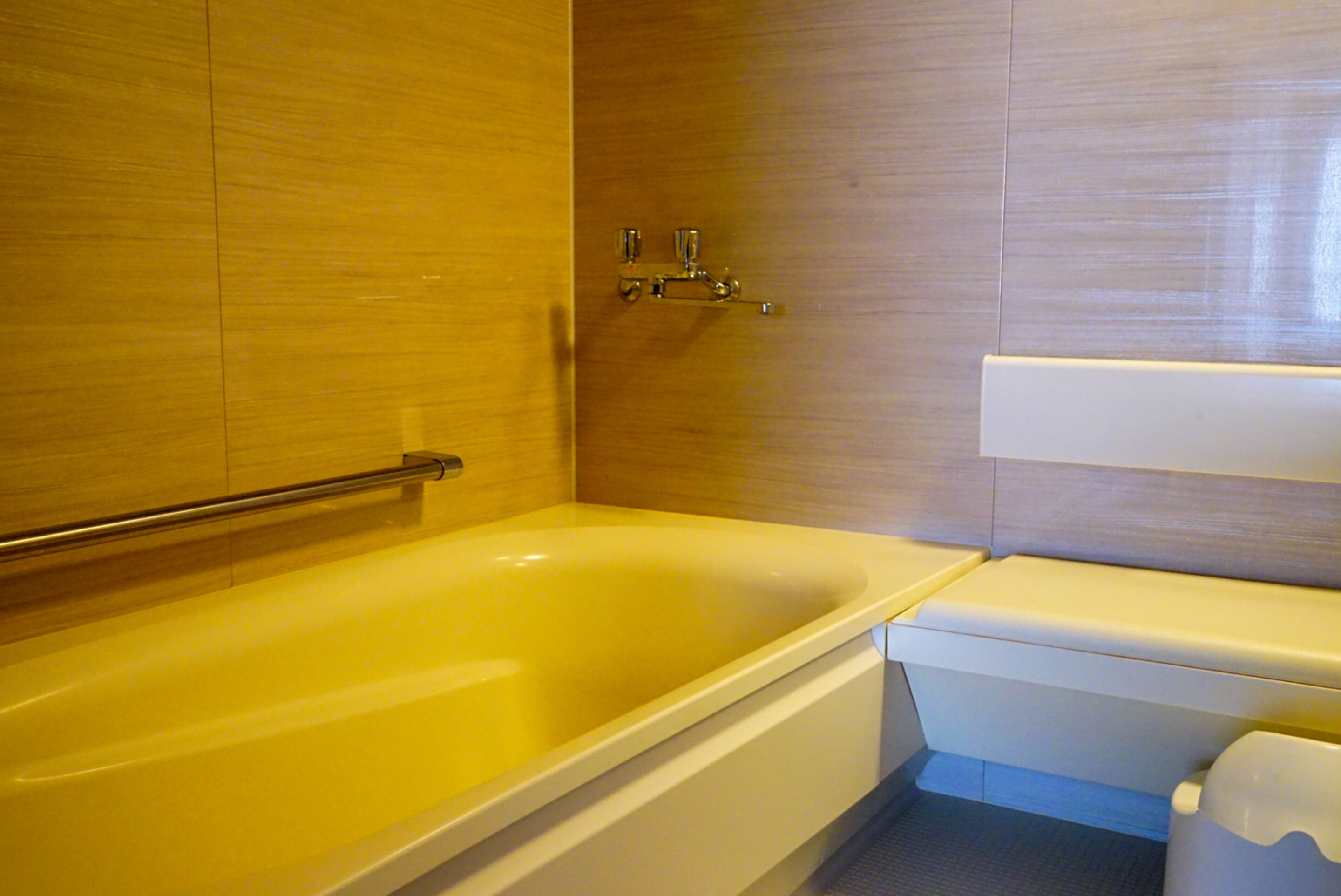 A bathroom with a bathtub, toilet, and a shower area.