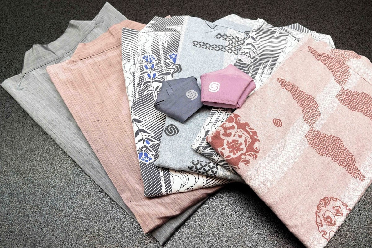 A collection of folded textiles with various patterns and textures.