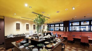 A buffet setup with various food items and a decorative plant. - Daiwa Roynet Hotel Kyoto Ekimae PREMIER (Kyoto)