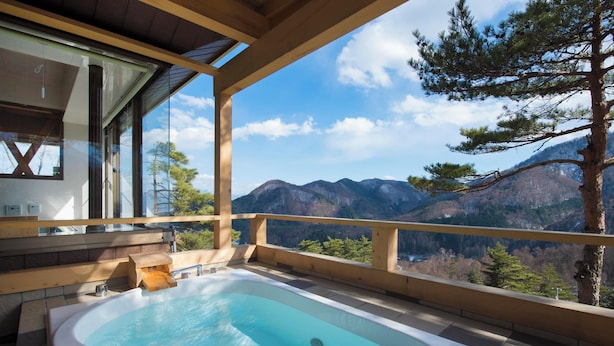 A hot tub on a balcony with a mountain view.