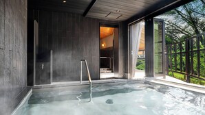 A modern indoor swimming pool with a wooden deck and a glass wall. - AZUMINO KOGEN RESORT (Azumino)