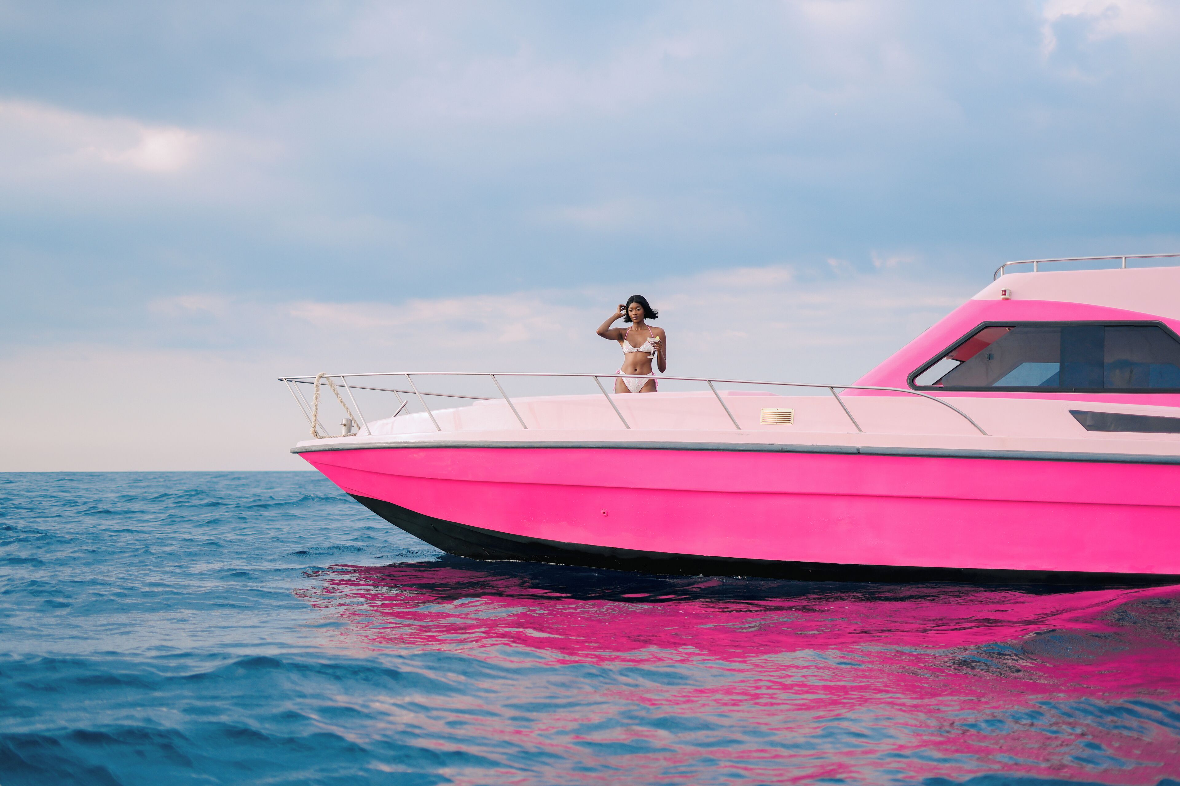 A boat with a person standing on the deck.