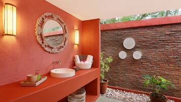 Relax in this serene bathroom with a large mirror, wall-mounted lights, and a stylish sink.