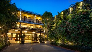 A hotel with a traditional architectural style, featuring a two-story structure with a balcony on the upper floor. - Silkotel Hoi An (Da Nang)
